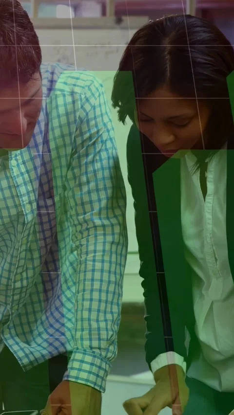 Vertical video: Man pointing table causing green chart overlay, woman leaning Stock Footage 331271151