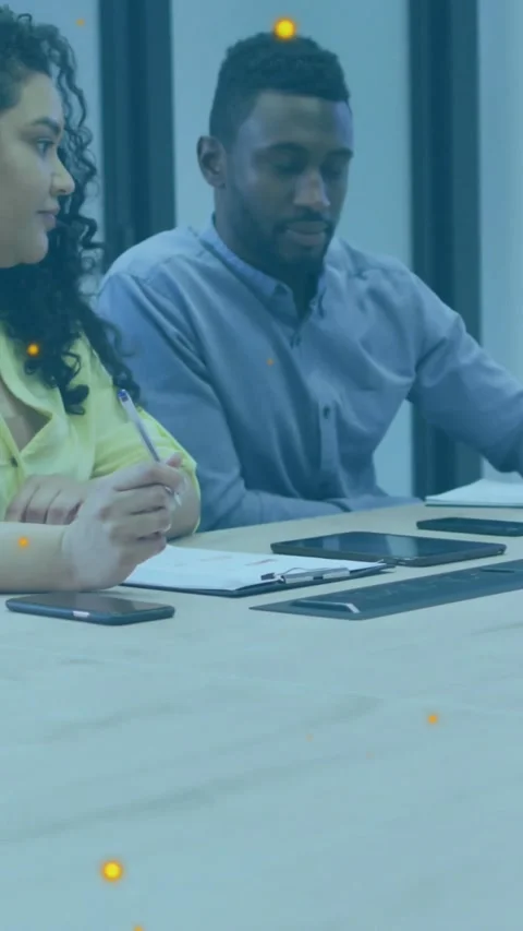 Vertical video: Man pointing in tech meeting showing motion graph on tablet Stock Footage 331029718