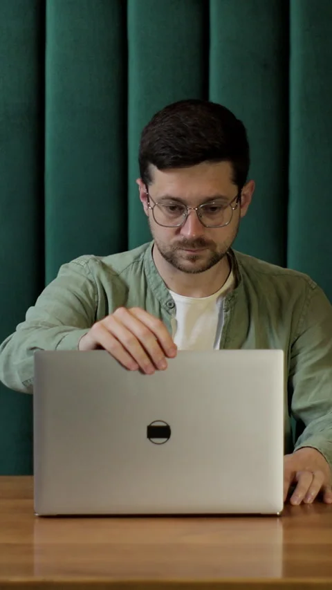 Vertical video. Man preparing to work in a coffee shop with his laptop. Stock Footage 345234682