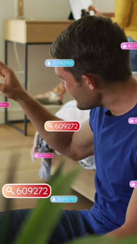 Vertical video: Man raising arm and pinching to select on couch, tech UI badges Stock Footage 334046620