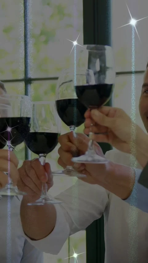 Vertical video: Man raising glass and talking, urging team clinking, sparkles Stock Footage 333556523