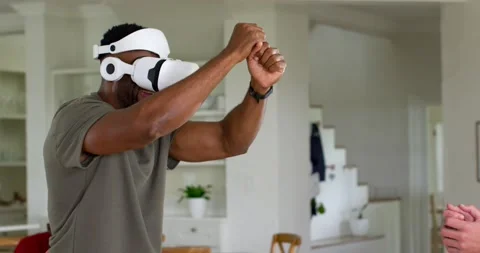 Vertical video: Man raising hands after VR gaming cue, manipulating virtual Stock Footage 340982239