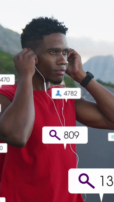 Vertical video: Man reaching for earbud, adjusting earbud while preparing to run Video stock 332775556