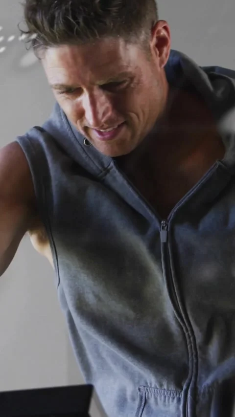Vertical video: Man reaching handle, logging fitness on screen while code dots Stock Footage 330580636