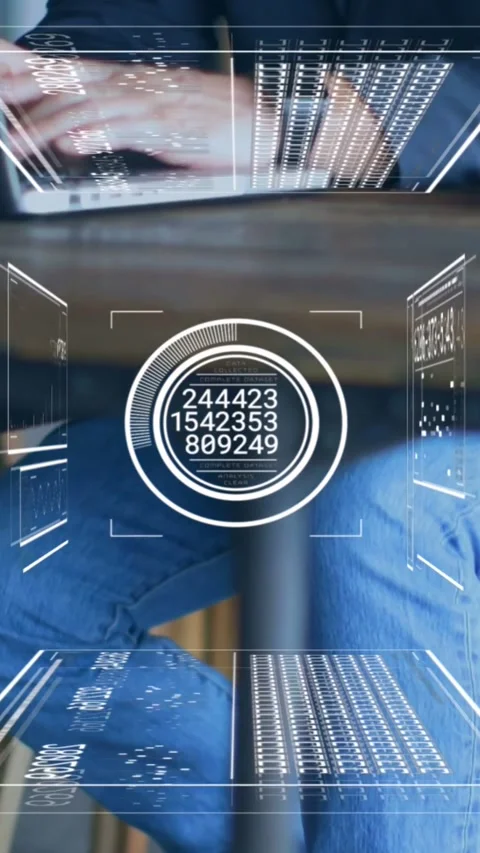 Vertical video: Man reaching laptop and typing for analytics, HUD updating Stock Footage 334544612