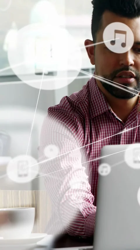 Vertical video: Man reaching laptop, typing and working while tech icons forming Stock Footage 334604960