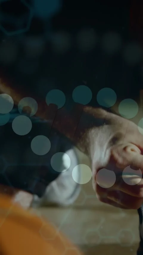 Vertical video: Man reaching, picking up item, rotating as tech code hex bokeh Stock Footage 332747500