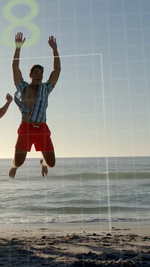 Vertical video: Man reacting to countdown grid and launching into jump on beach Stock Footage 334128198