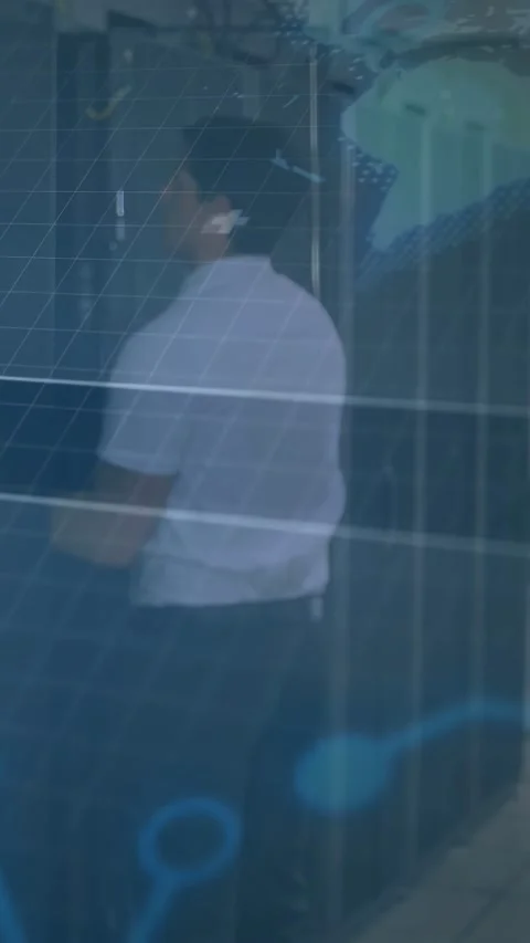 Vertical video: Man reacting to offscreen cue standing at panels while tech orb Video stock 332594918