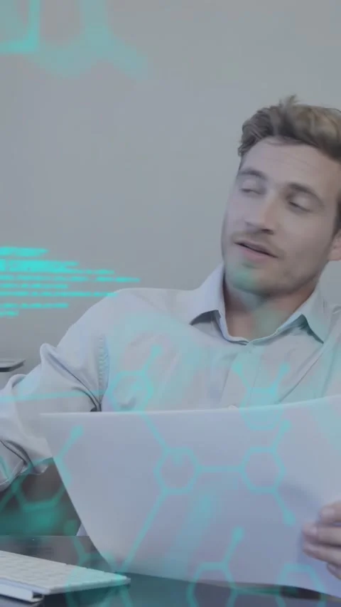 Vertical video: Man reading doc for tech, reacting offscreen while cyan hex Stock Footage 330359126