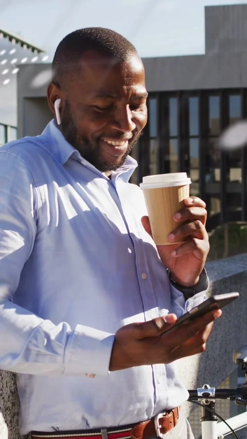 Vertical video: Man reading work alert on phone with coffee while code dots Stockbeeldmateriaal 332734661