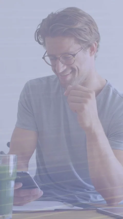 Vertical video: Man reading work message on phone, smiling with light streaks Stock Footage 334297693