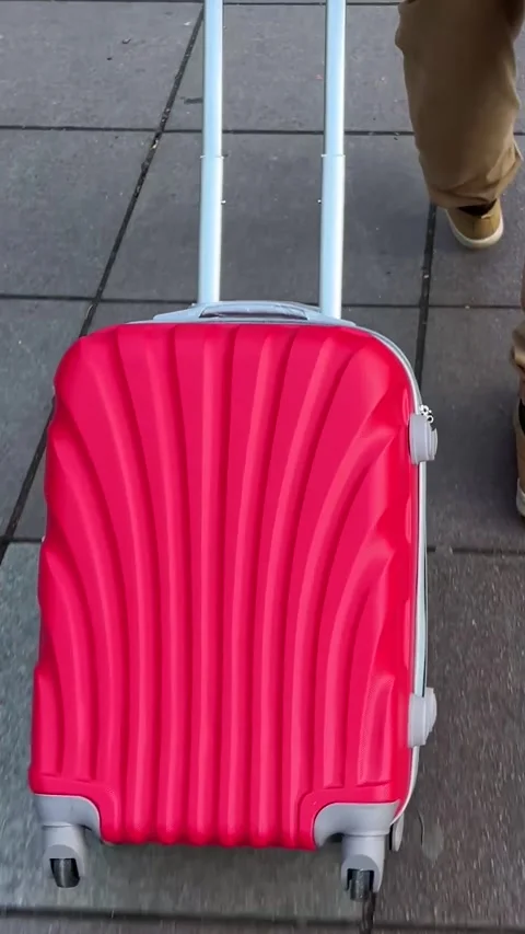 Vertical video. Man with red suitcase in city street Video stock 278517932