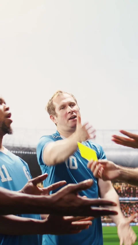 Vertical Video Man referee raising yellow card as warning for angry player on Stock Footage 338046992