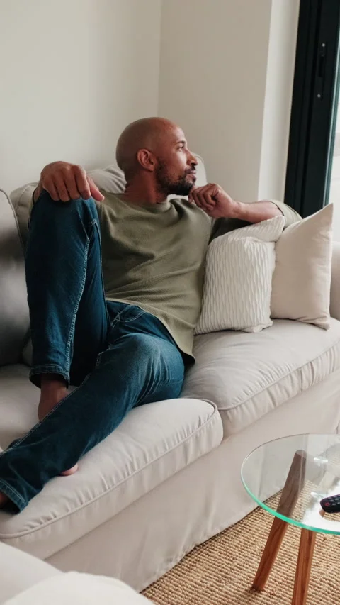Vertical video, Man Relaxing at Home on Sofa Stock Footage 312638815