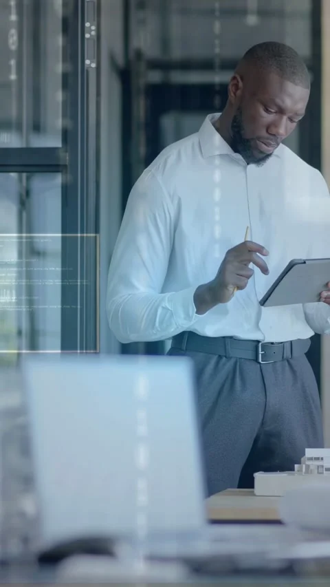 Vertical video: Man reviewing tablet data in tech, tapping stylus and causing Stock Footage 333513204