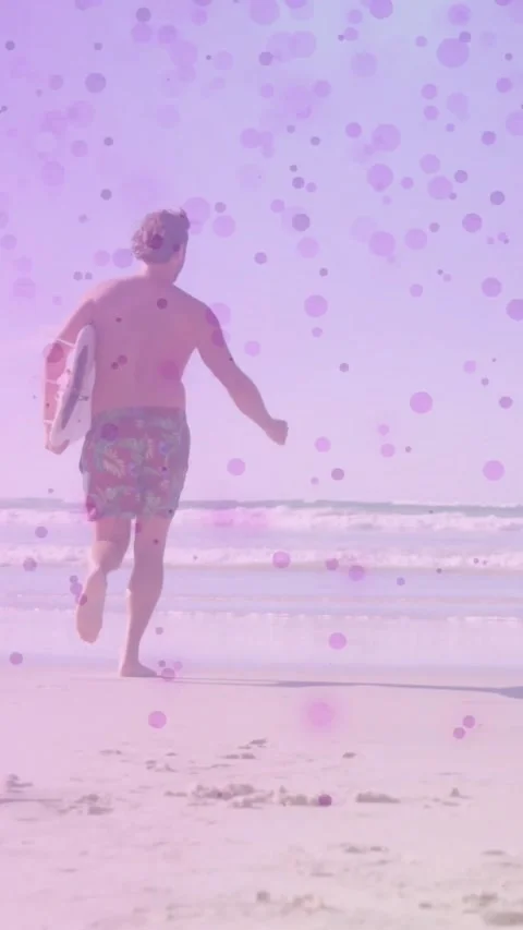 Vertical video: Man running to sea seeing waves, holding board as speckled Stock Footage 331291732