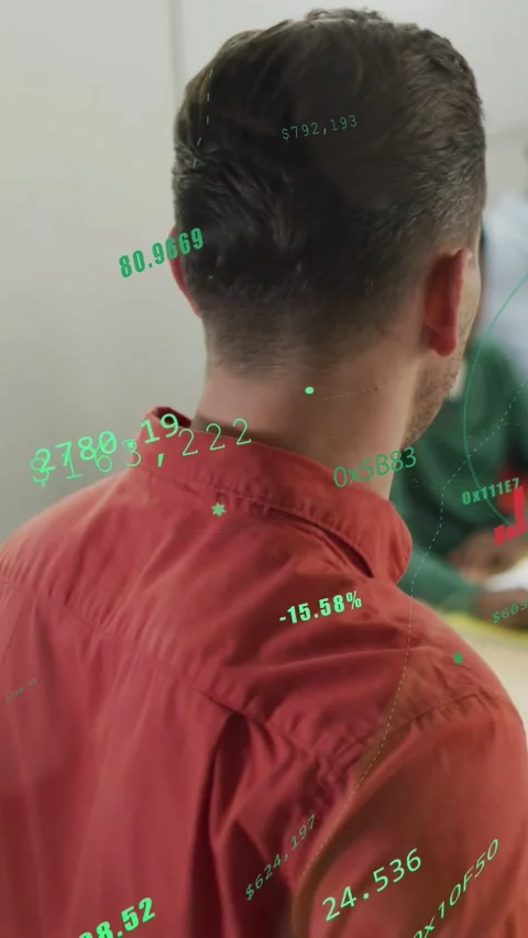 Vertical video: Man in rust shirt turning and presenting moving green HUD stats Stock Footage 333603728