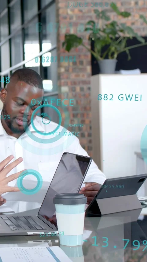 Vertical video: Man scanning doc at desk, hands gesturing, using laptop and Stock Footage 333465456