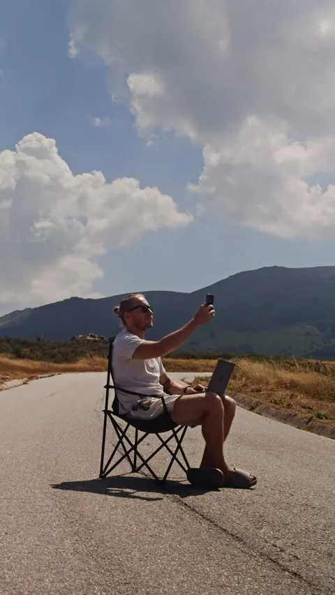 Vertical Video of Man Searching for Mobile Signal on Mountain Road Vídeos de archivo 346547596