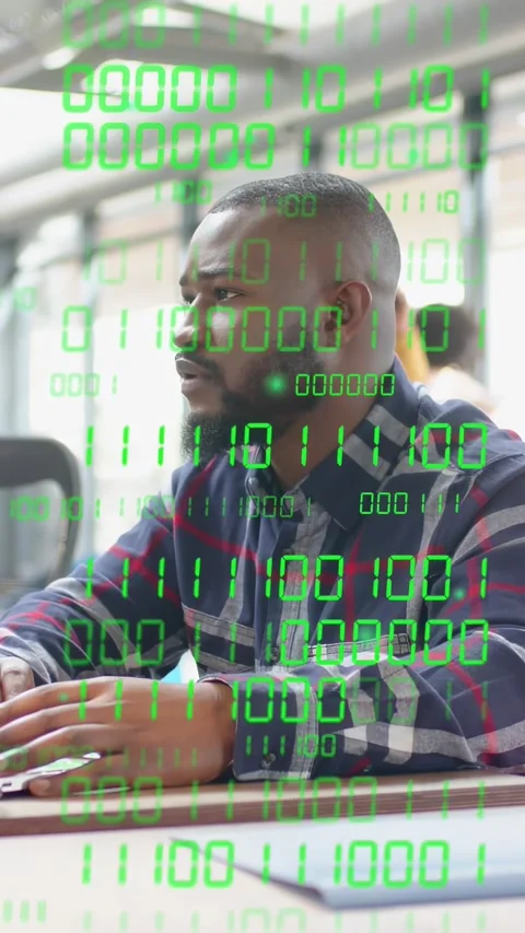 Vertical video: Man seated tracking passing coworker on phone in tech, binary Stock Footage 333912754