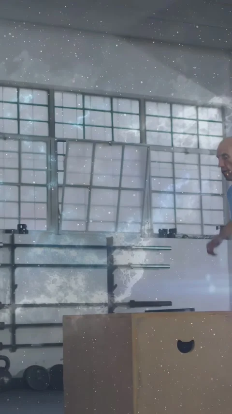 Vertical video: Man shifting then jumping off plyo box, starry overlay tracing Stock Footage 334543755