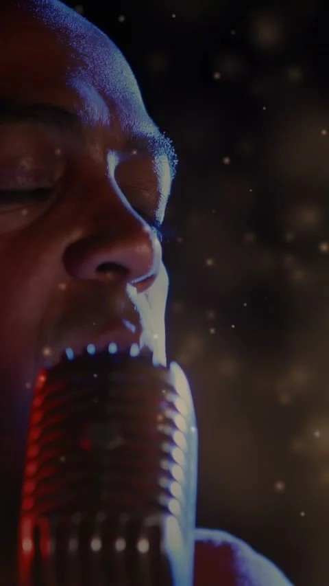 Vertical video: Man singing into mic as camera pullback revealing face and Stock Footage 332734583