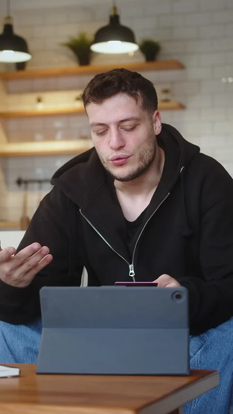 Vertical video. Man sit on sofa at home entering credit card number on tabl.. Stock Footage 273428718