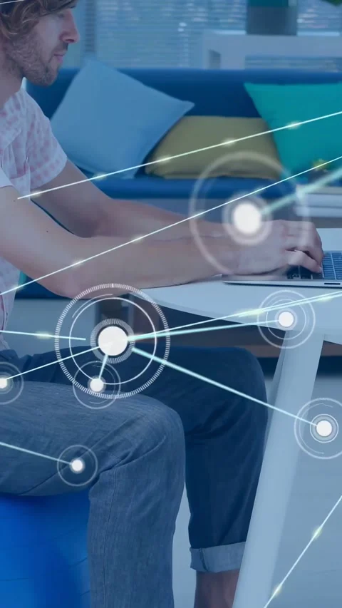 Vertical video: Man sitting on ball typing laptop causing network nodes to 스톡 동영상 334598527