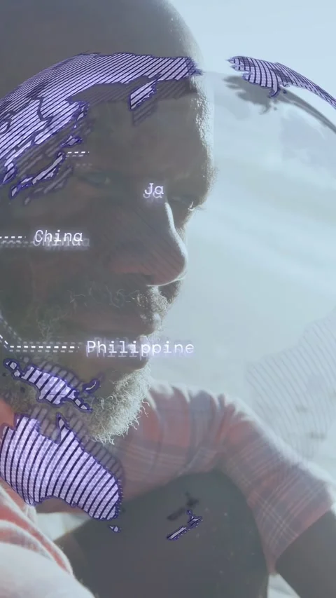 Vertical video: Man sitting on beach, map rising on face, becoming purple globe, 스톡 동영상 332823741