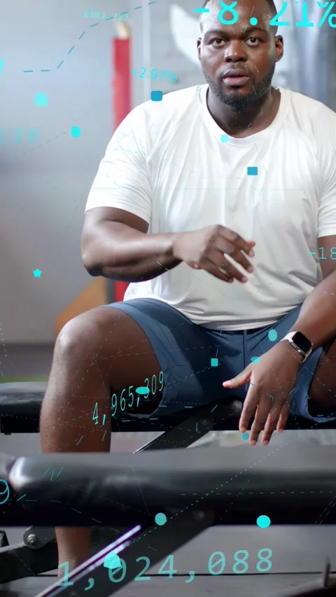 Vertical video: Man sitting on bench wiping forehead after set, teal health Stock Footage 334297234