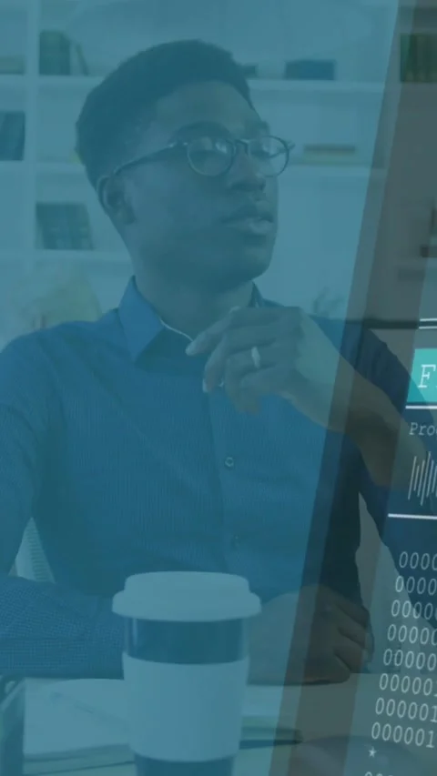 Vertical video: Man sitting at desk HUD sliding in checking tech code near cup Stock Footage 331128921