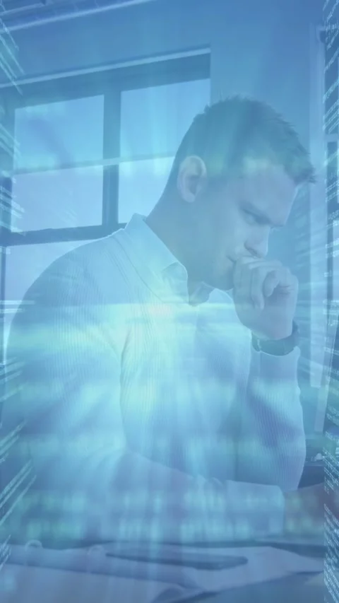 Vertical video: Man sitting desk reviewing data, causing tech overlay pulsing Stock Footage 332806861