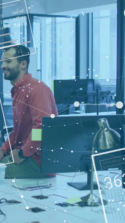 Vertical video: Man sitting tech desk edge hearing off-frame colleague AR Stock Footage 333174954