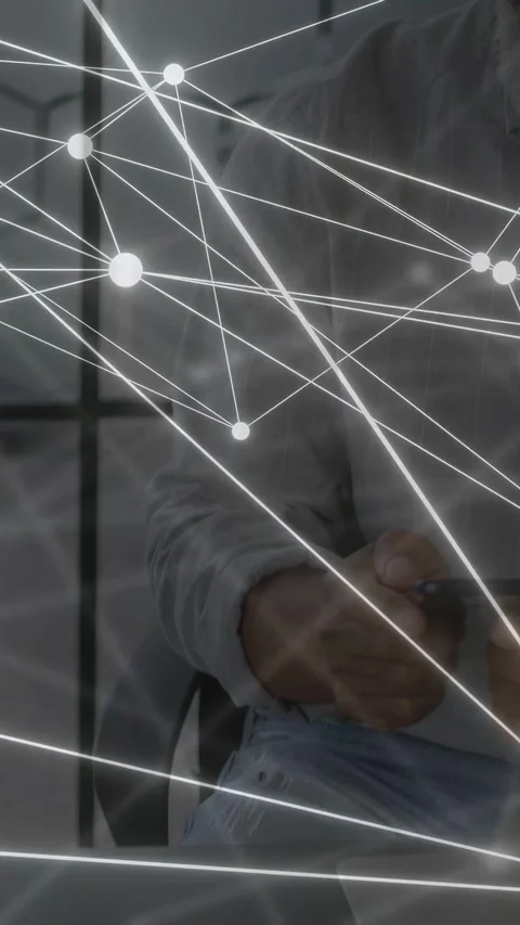 Vertical video: Man sitting in tech tapping phone and checking chart while Stock Footage 334792815