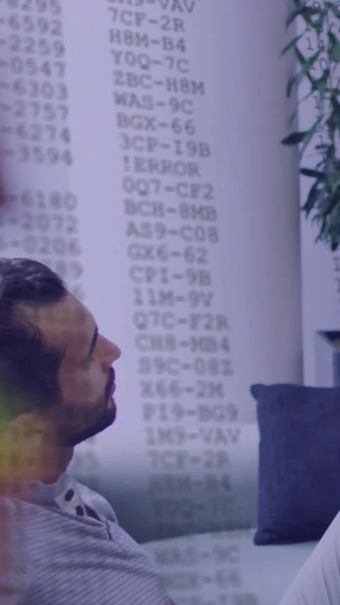 Vertical video: Man sitting turning while camera pulling back showing code Stock Footage 329841118