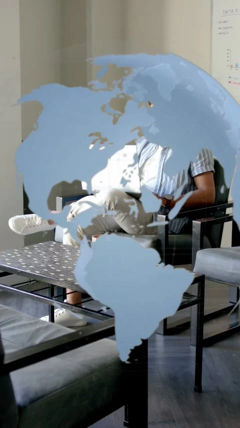 Vertical video: Man sitting typing on laptop in office, map decal shifting, Stock Footage 334770780