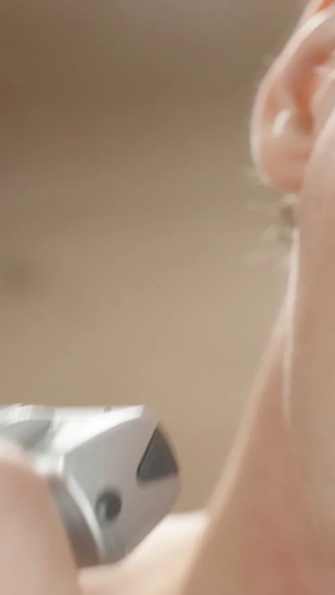 Vertical video. Man Slapping Cheek to Brush Off Hair and Shaving Remaining Stock Footage 277119016