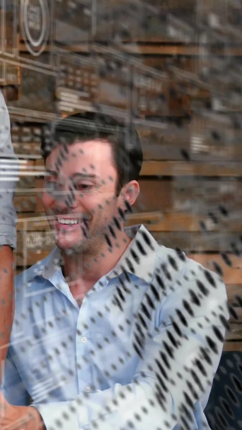 Vertical video: Man smiling after peer laptop tap, glass overlay passing, tech Stock Footage 331463910