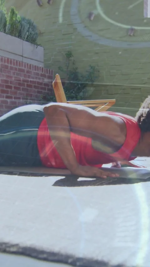 Vertical video: Man starting plank, doing pushups on mat, building fitness while Stock Footage 331739153