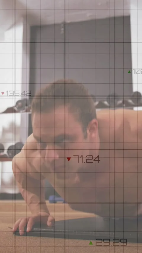 Vertical video: Man starting pushups on mat faint grid and charts rising and Stock Footage 332806847