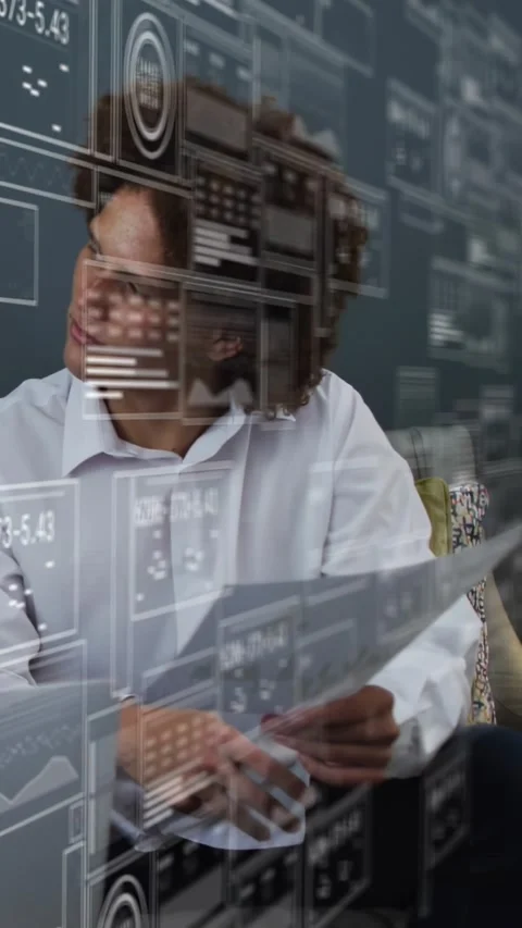 Vertical video: Man starting by reviewing docs, tapping laptop using HUD overlay Stock Footage 334386305