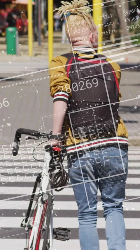 Vertical video: Man stepping to cross, pushing bike across crosswalk, HUD Stock Footage 331199309