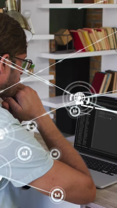 Vertical video: Man studying laptop in study, HUD appearing and expanding around Stock Footage 330260194
