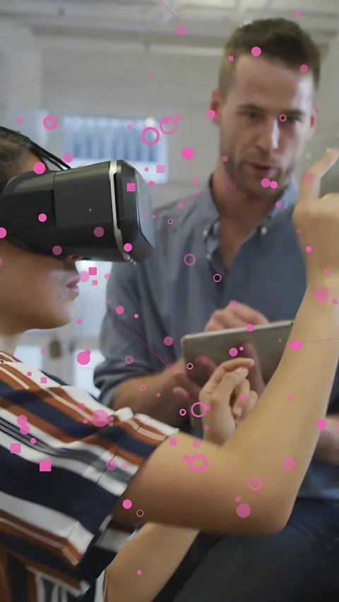 Vertical video: Man with tablet tapping to start tech demo as woman in VR Stock Footage 337543362