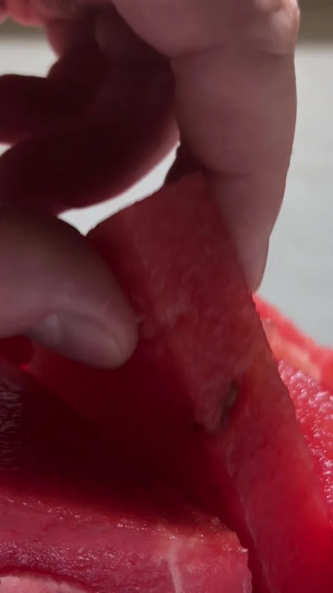 Vertical video. Man takes slice of fresh juicy tasty red raw sweet watermelon Stock Footage 286177097