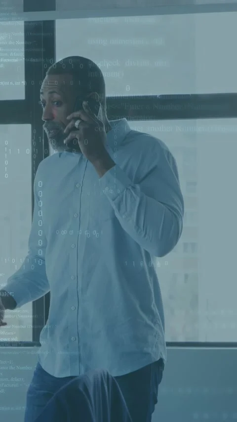 Vertical video: Man taking business call at window speaking as code around phone Stock Footage 333109651
