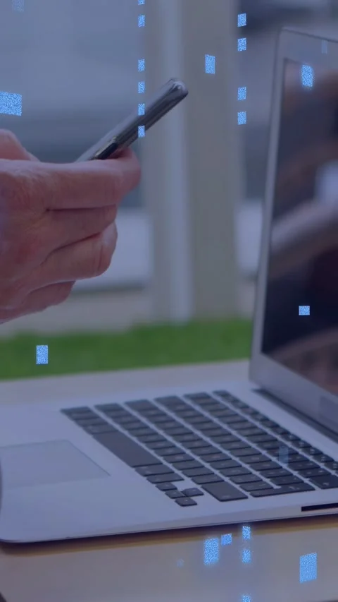 Vertical video: Man tapping and swiping phone for business at laptop, blue Stock Footage 335264387