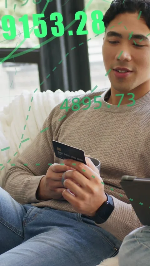 Vertical video: Man tapping card on sofa causing green AR data growing, checking Stock Footage 333304396