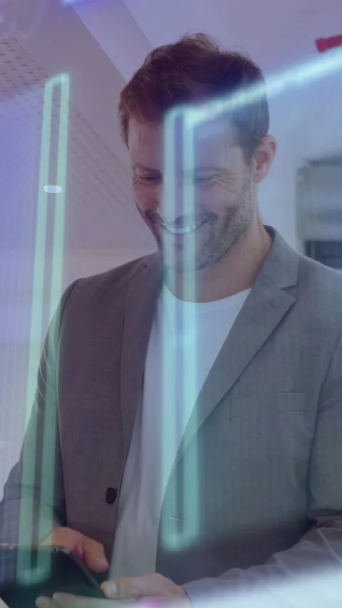 Vertical video: Man tapping device while checking business data in office, neon Stock Footage 333259695